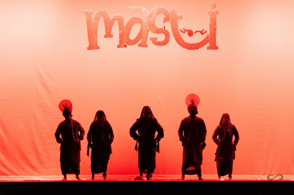 Dancers performing beneath the Masti banner